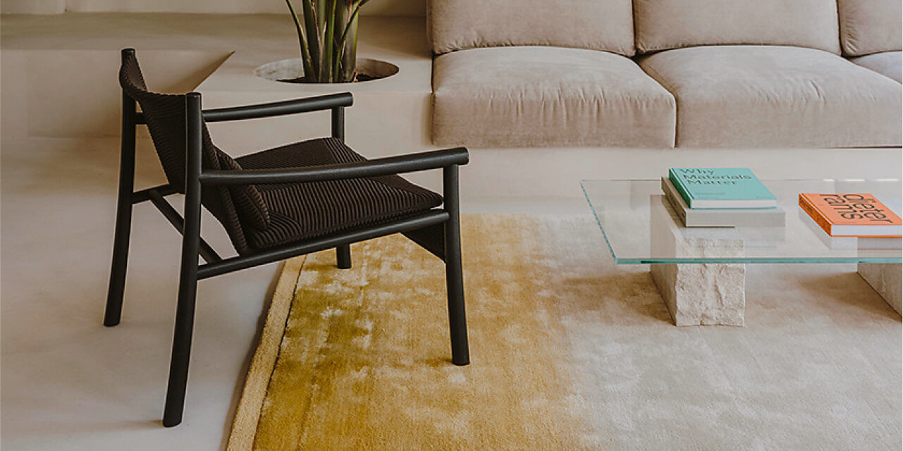 Armchair with black 3D knitted upholstery in a living room – fashion-inspired yarns, colours and textures