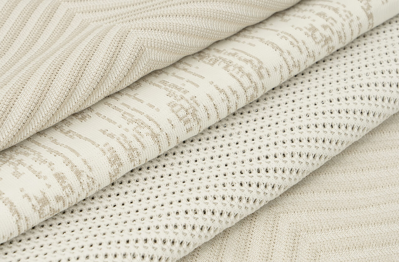 Close-up of a shape-knitted automotive textile: one yarn, varied patterns and breathable structures for function and design
